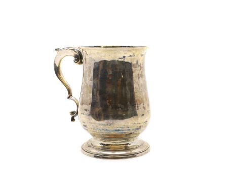 A George III silver mug by Hester Bateman, London 1781, of baluster form with acanthus capped handle and stepped circular foo