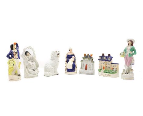 A collection of Staffordshire pottery 19th century, comprising a man on horseback, two female figures, a pair of seated spani