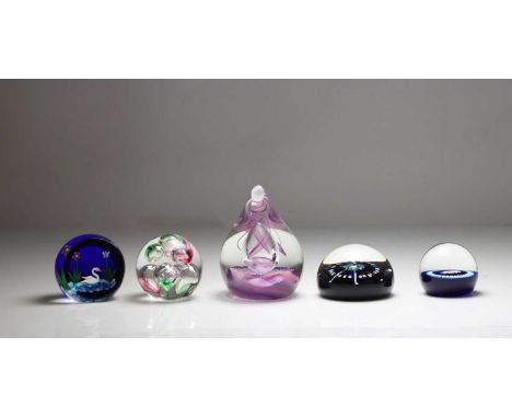 A group of paperweights comprising a William Manson paperweight, decorated with a lampwork swan, a Caithness paperweight, wit