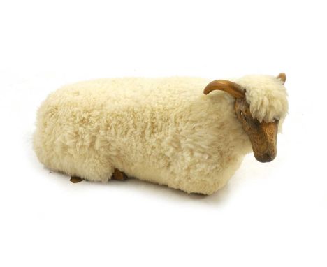 A 'Goring Hotel' carved oak and wool sheep stool, of recent manufacture, by Sheepshape Co Ltd, modelled resting,98wide46cm de