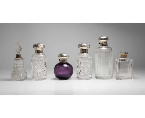Six silver-mounted scent bottles, various dates, one with an etched amethyst body, one with an enamelled collar, 10cm to 16cm