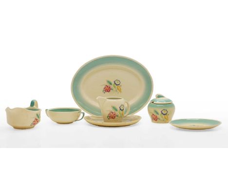 A collection of Susie Cooper pottery wares, comprising two pouring jugs, a meat plate and similar, the whole with foliate cen