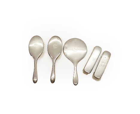 A silver dressing table set by Martin Hall &amp; Co Ltd, Birmingham 1918, comprising a mirror, 28cm overall and four brushes,