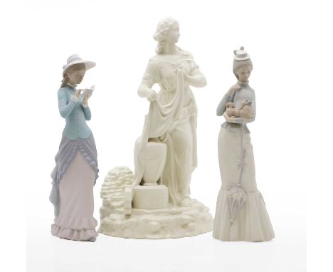 A Lladro girl reading a book and another of a girl carrying a dog, modern, 36cm and 37.5cm high, and a modern Belleek figure 