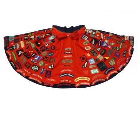 A World War Two Voluntary Aid Detachment nurse's cape,  owned by Joyce Rycroft (1918-2009), 1940s, navy wool with scarlet lin
