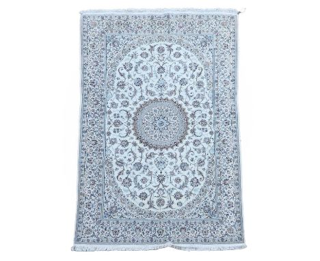 A signed Nain wool rug, with foliate motifs to a pale ground, signed,278 x 163cmCondition ReportMinor wear, surface marks and