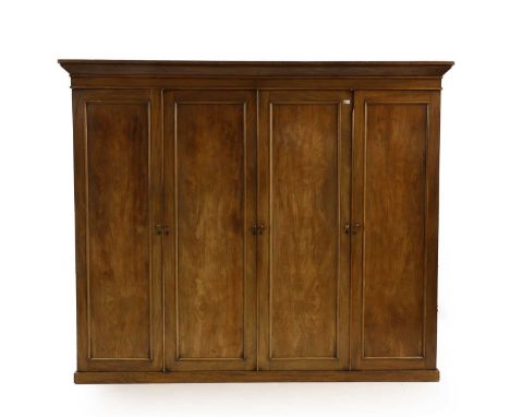 A Victorian mahogany wardrobe, of plain form with two pair of cupboards, the interior centred with slides and drawers, flaked