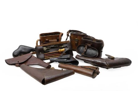 A World War II cleaning kit in a leather case, containing rods and brushes,25cm wide, together with five leather revolver cas
