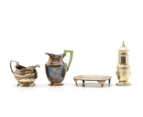 A George III silver teapot stand London 1806, of rounded rectangular form with engarved detail on scroll feet, 15cm wide, tog