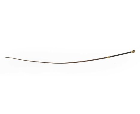A Victorian gold-topped riding crop the finial with chased motifs and an entwined snake with turquoise cabochon, ruby and gar