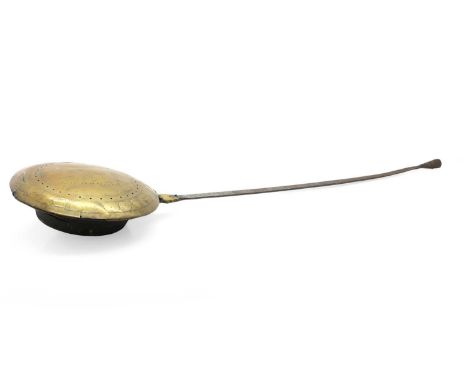 A brass warming pan 17th century, the hinged circular pan with engraved and pierced decoration fitted iron handle30cm diamete