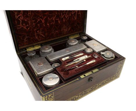 A Regency rosewood and brass inlaid vanity box mid 19th century, with brass banding and foliate border, with recessed handles