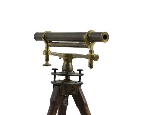 A brass theodolite on a mahogany folding tripod stand, fitted location spikes to tripod support ends31cm wide128cm highCondit
