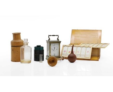 An apothecary bottle in boxwood case c.1810, 16.5cm high, together with a brass cased carriage clock, 12cm high, a treen ear 