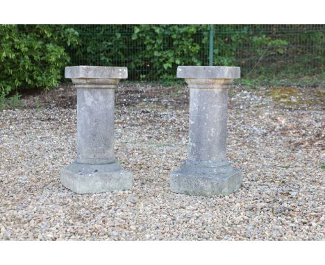 A pair of round Tuscan cast stone plinths the square tops on column support and plinth base36cm wide36cm deep