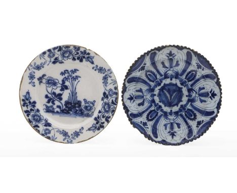 A tin glazed charger 18th century of scalloped circular form, with stylised foliate decorated centre within a flowerhead and 