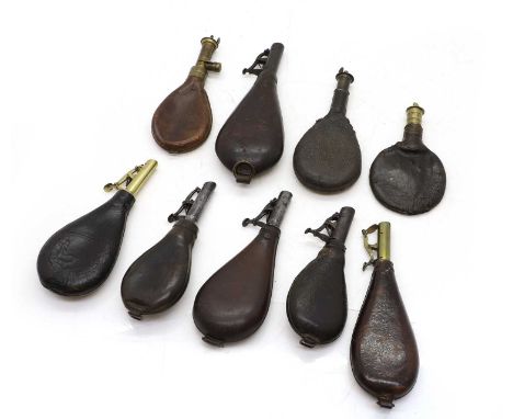 A collection of nine leather shot flasks mostly 19th century,the leather pear form bodies with brass or steel mountsShipping 
