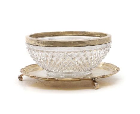 A silver salver, Birmingham 1936of circular form with pie crust border on scroll feet25.5cm diameter together with a cut glas
