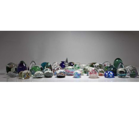 A collection of glass paperweights to include a Caithness paperweight, a paperweight inkwell, a Phoenician paperweight, and V