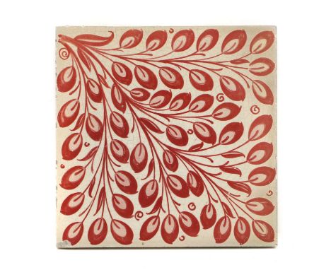 William De Morgan (1839-1917) a ruby lustre tile, c.1880, decorated with a diagonal leafy spray, impressed mark,15.3cm square