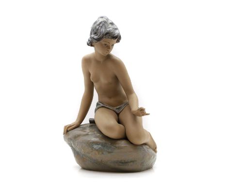 A Lladro figure of a nude seated on a rock, modern, 42.5cm highCondition ReportGood overall. No issues or chips.