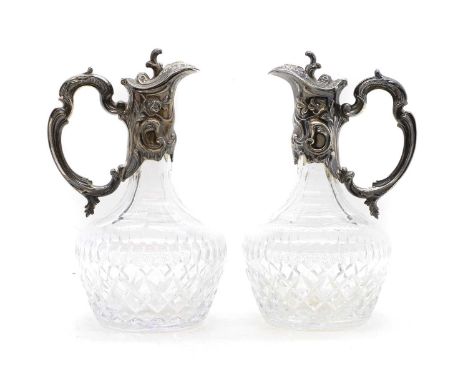 A pair of silver-mounted glass claret jugs 19th century, Continental, the mounts marked 925, with rococo floral and foliate d