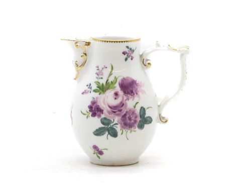 A Meissen porcelain cream jug, late 18th century, decorated with painted purple flowers, with moulded rococo scrolls, painted