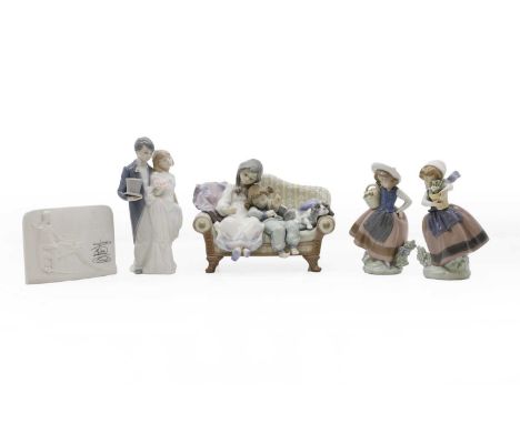 Four Lladro figures of children, a young married couple and two girls on a sofa, modern, largest 22cm wide, and a Lladro Coll