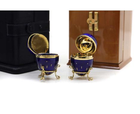 Two Faberge enamelled ‘Easter’ eggs,  modern, each 6.5cm high, one in a fitted wood case, with sleeve, the other in a leather