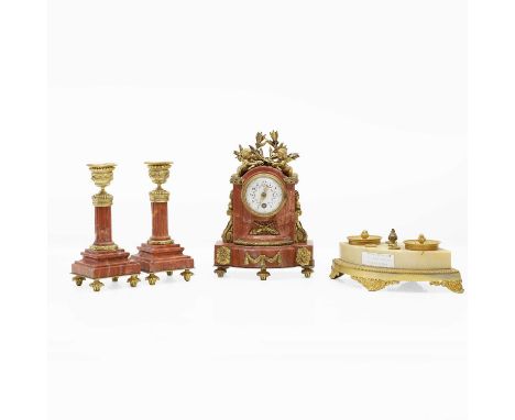 A group of ormolu mounted marble items 19th century, comprising a rouge marble timepiece garniture, the timepiece with a sing