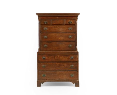 A George III mahogany inlaid chest on chest, the front corners with fluted pilasters, flanking the top section, over drawers 