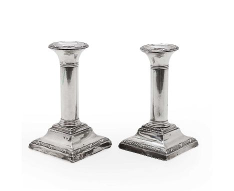 A pair of silver column candlesticks, by S Blanckensee &amp; Son Ltd, Chester 1912, on square stepped loaded bases, 13cm high