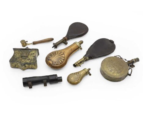 A group of powder flasks 19th century, comprising three leather examples, largest 22cm, a copper example, embossed with a she