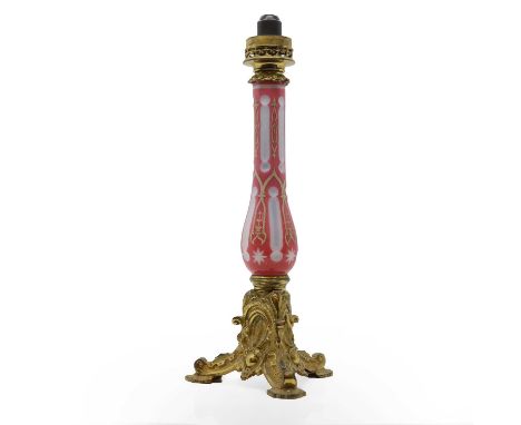 A Bohemian cased glass and gilt oil lamp, 19th century, the pink glass column with white and gilt decoration, with pierced br