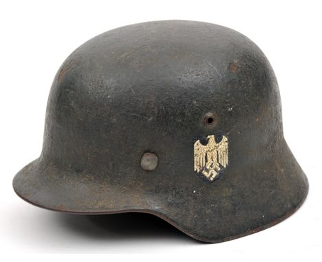 A Third Reich double decal M35 steel helmet,  with textured dark grey finish and Army eagle and national decals, the inner br