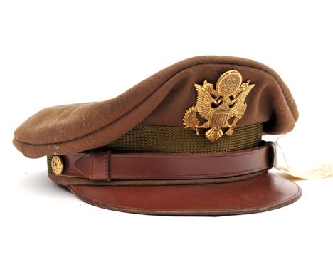 †A WWII US Army officer’s khaki peaked cap, brown leather peak and chinstrap, gilt buttons and badge, and a French Foreign Le