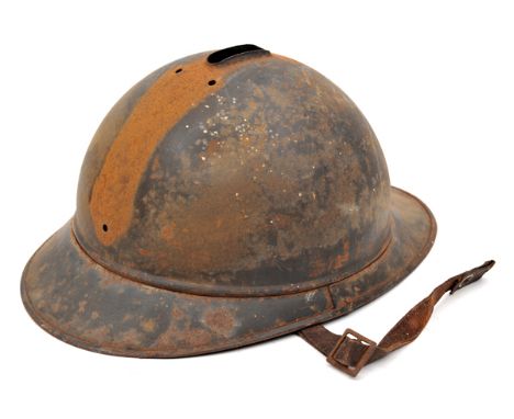 A WWI French Adrian pattern steel helmet, with leather lining and chinstrap. QGC (rusted, no crest or badge).                