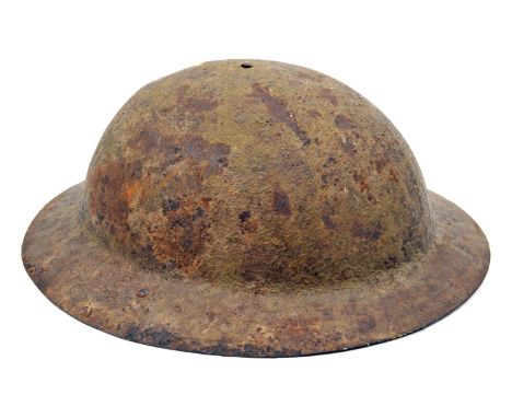 A WWI “raw edged” steel helmet,  with loops for chinstrap and part of the strap with buckles, (heavily rusted), and an office