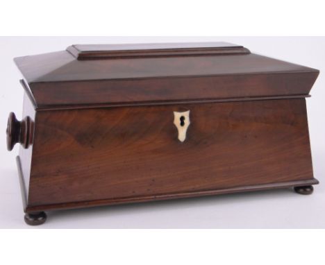 A 19th century figured mahogany sarcophagus shaped tea caddy,with fitted inner caddies, length 14".
