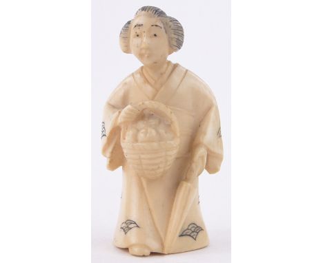 A Chinese carved ivory netsuke,in the form of a woman carrying a basket, signed under base, height 2".