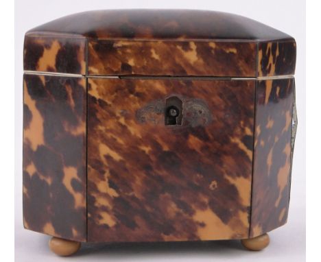 A small 19th century tortoiseshell tea caddy of canted rectangular form,with tortoiseshell inner lid and ivory feet, length 4