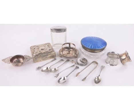 Group of silver items,including a relief embossed cigarette box, a blue enamel topped powder jar, tea strainer on stand, napk