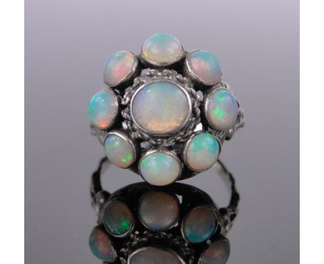 An opal cluster ring,unmarked silver settings, setting height 19mm, size O