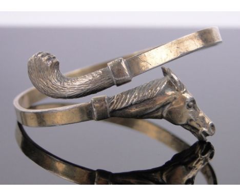 A silver gilt horse design sprung bangle.