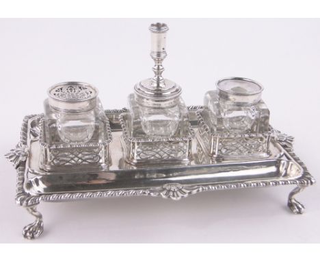 A George III cast silver desk stand,with cast gadrooned edge, cut-glass inkwells and pounce pot and candlestick by Samuel Her