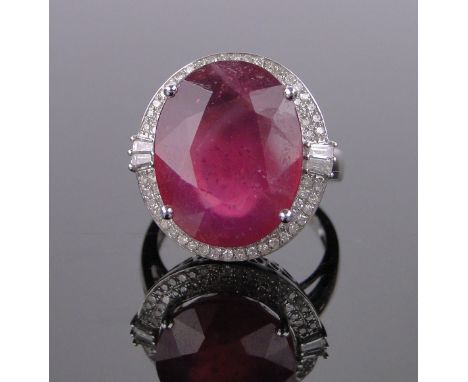 A large 14ct white gold ruby and diamond cluster ring,ruby approx. 6cts, setting height 19mm, size M.