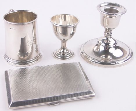 A group of silver items,including christening mug, cigarette case, eggcup and candlestick, (4).