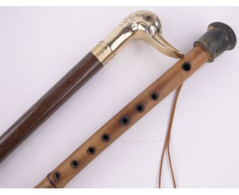 A bamboo walking stick in the form of a flute,and a brass ducks head handled walking cane, unscrewing to reveal a small flask