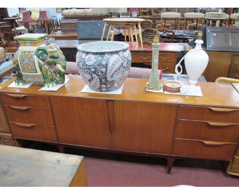 Mcintosh Teakwood Sideboard, with twin central cupboard doors, flanking drawers, 201cm wide.some light surface scratches and 