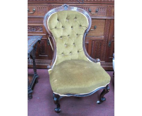 A XIX Century Walnut Nursing Chair, with upholstered button back and seat on cabriole legs.